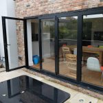 Aluminium bi-fold doors with through door open