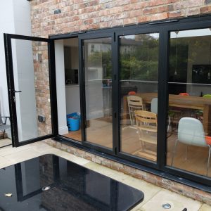 Aluminium bi-fold doors with through door open