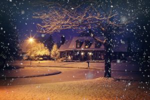 Snowy home at night