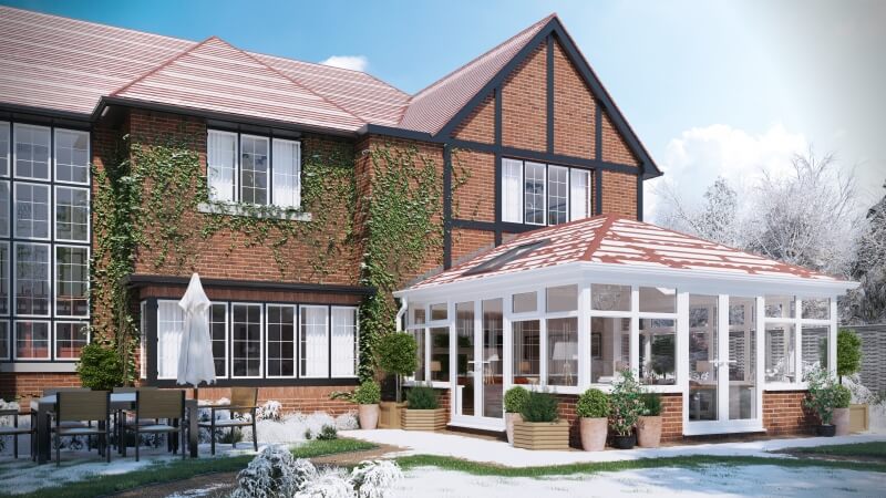 Edwardian conservatory with a tiled roof in the snow