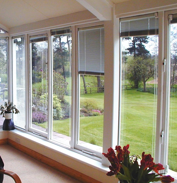 Floor to celling windows looking out on to a back garden. 