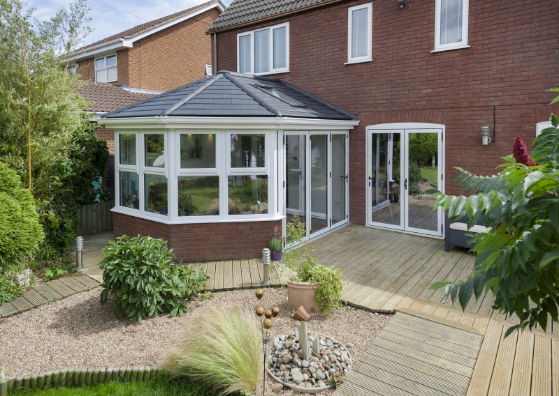 tiled conservatory roof in sunny garden