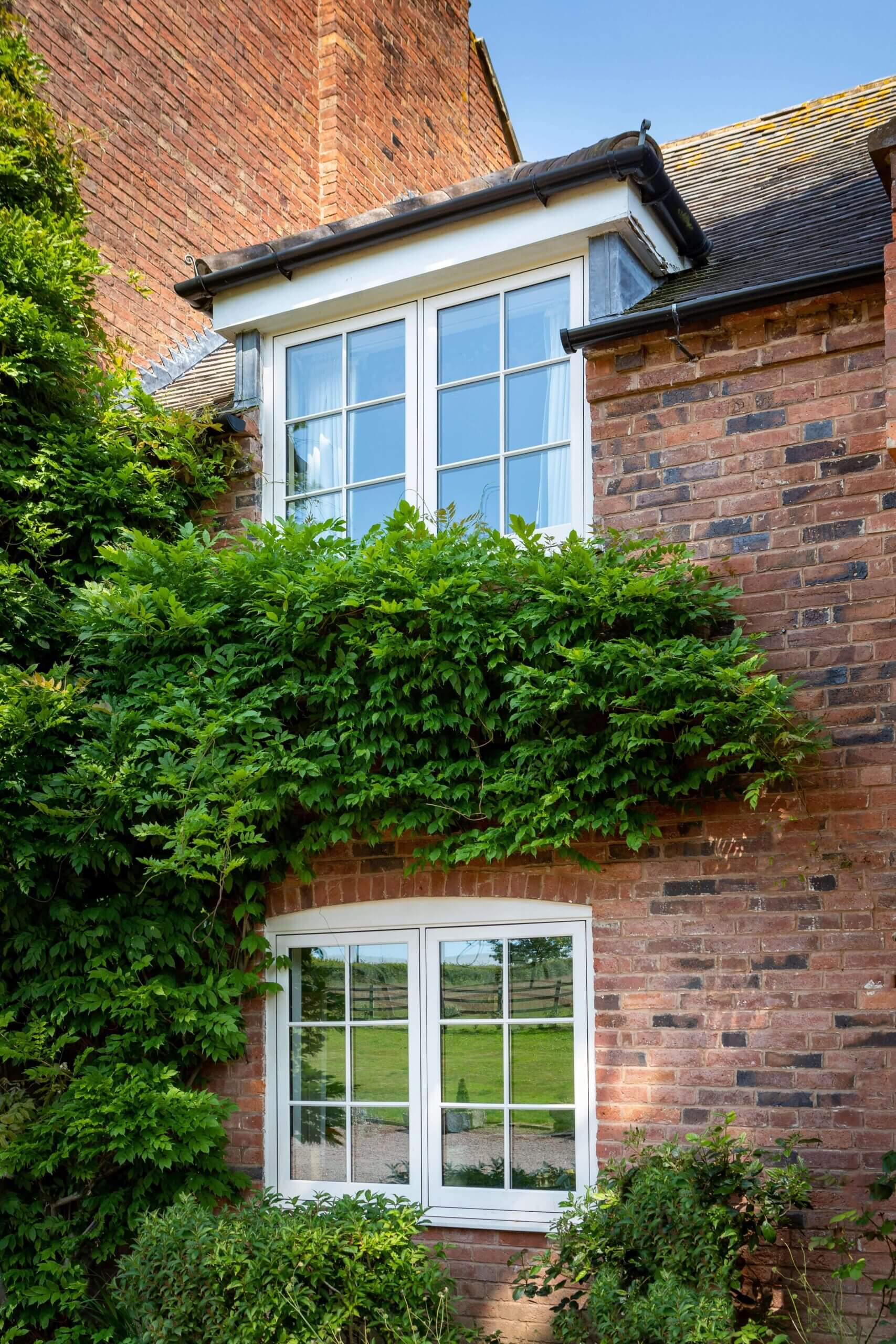 White casement windows with astragal bars