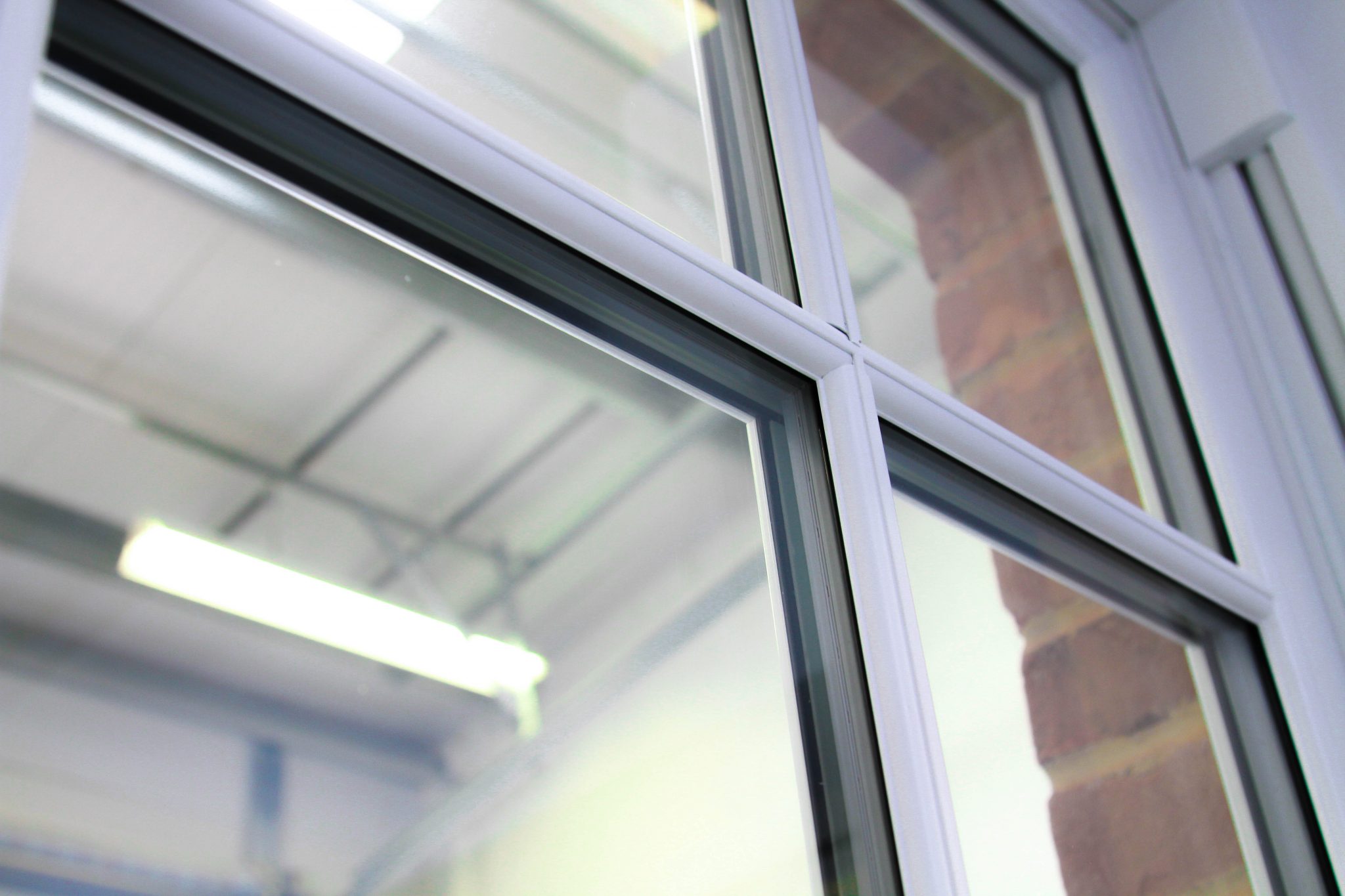 White casement windows with astragal bars, close up